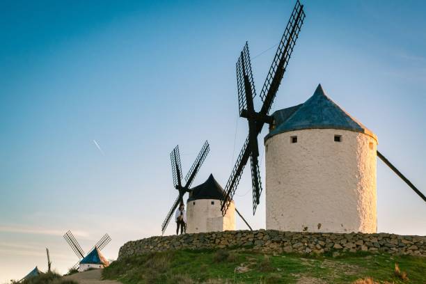 istock Idyllic landscape featuring windmills perched on a rolling hill, surrounded by lush green grass 1497930845