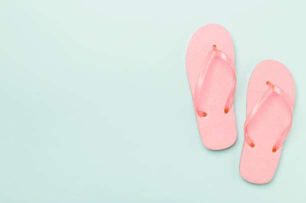 istock Bright flip flops on color background, top view 1497933224