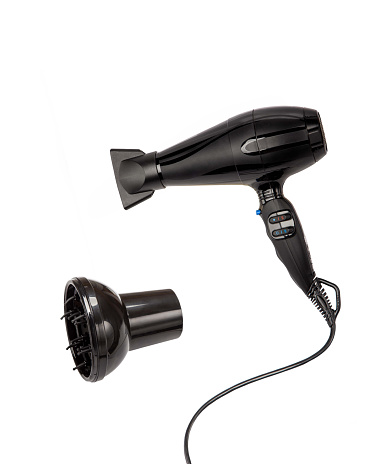 Professional black hair dryer with hair styling attachments isolated on white background. Hairdryer with hair styling nozzle, universal diffuser.