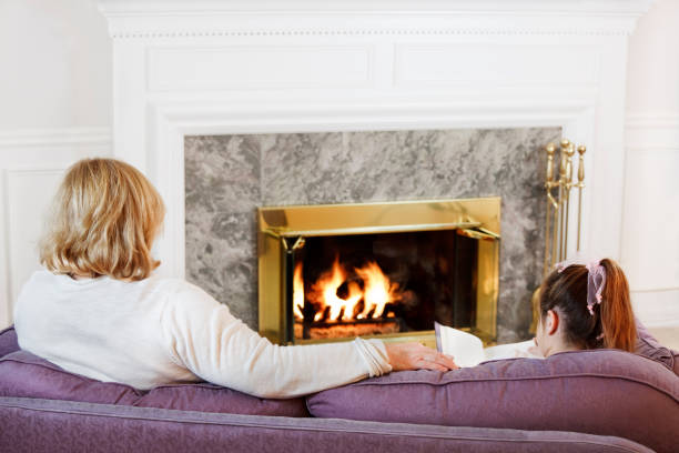 istock Mother & daughter by the fire 1497935635
