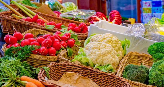 A market stall with various colorful varieties of vegetables.