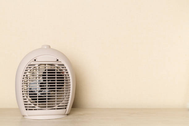 istock Modern electric fan heater on light table 1497939586
