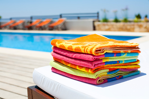 Pack of towels nearby the pool