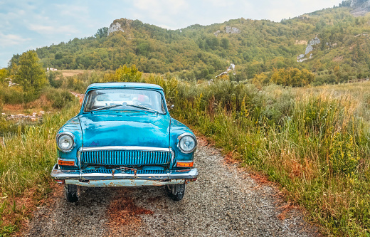 old retro car on a mountain road