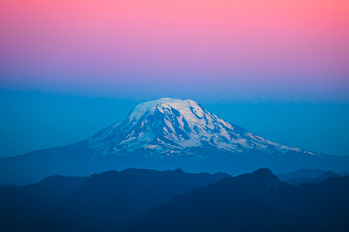Mount Rainier with pastel bands of colour at dusk with snow on top. Washington State, USA.