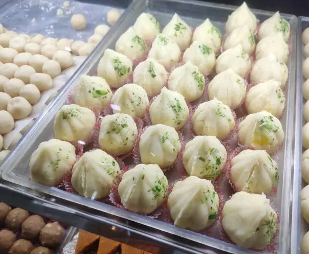 Photo of Modak is an Indian sweet dumpling dish popular in Indian cultures. The sweet filling inside consists of freshly grated coconut and jaggery while the outer soft shell is made from rice or wheat flour.