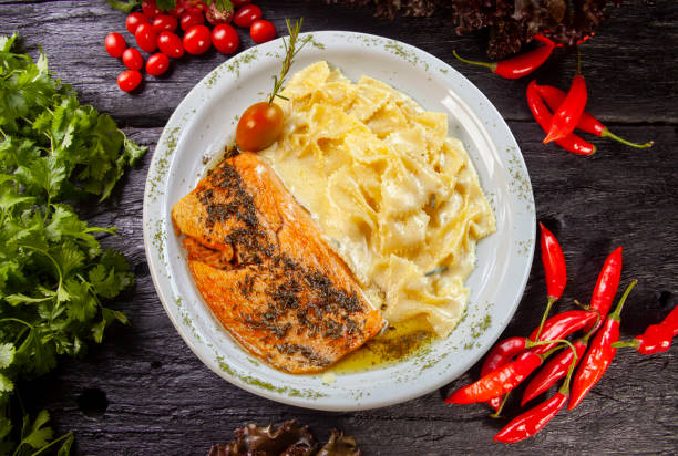 istock Pasta with white sauce and grilled salmon 1497951062