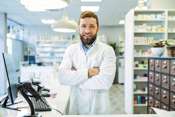 istock Young Smiling Man Pharmacist with arms crossed looking at camera 1497951140
