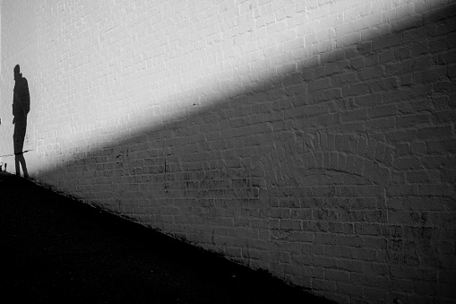 Men shadows on the concrete wall.
