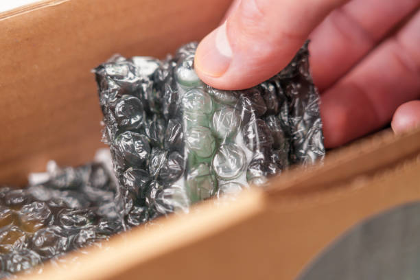 istock Bubble wrapped items in opened cardboard gift parcel box and in hand 1497954742