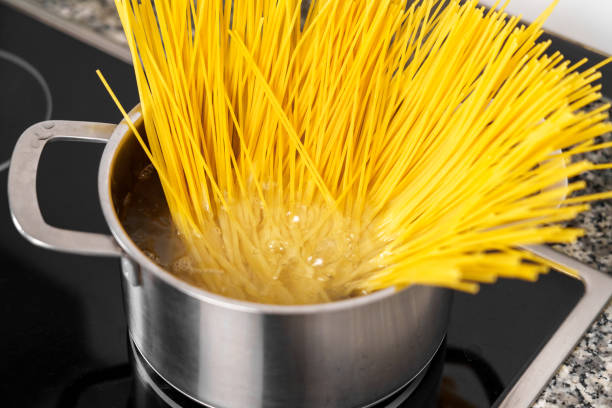 istock Cooking spaghetti in a pot of boiling water 1497954794
