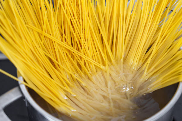 istock Cooking spaghetti in a pot of boiling water 1497954807