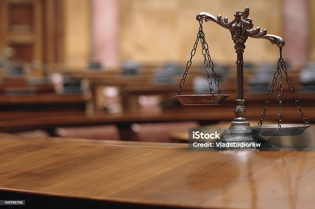 Decorative Scales of Justice in the Courtroom Symbol of law and justice in the empty courtroom, law and justice concept. Equal-Arm Balance Stock Photo