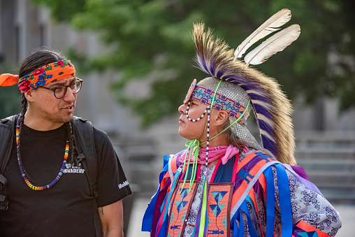 Toronto Ontario, Canada- June 7th, 2023: two native Canadians talking to each at the walk with Amal at Toronto Hall, which is part of the Luminato Festival.