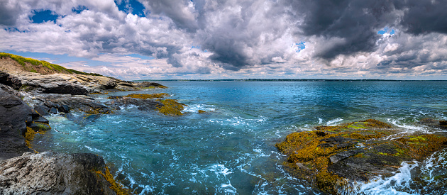 Dramatic seascape in a rocky coastline with stormy clouds in New England, America