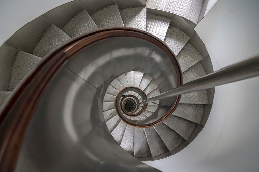 Old-fashioned spiral staircase. Black and white and low angle shot.