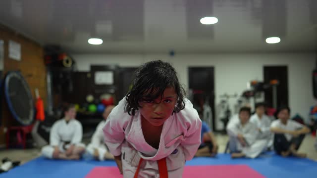 Child boy bowing during a karate class