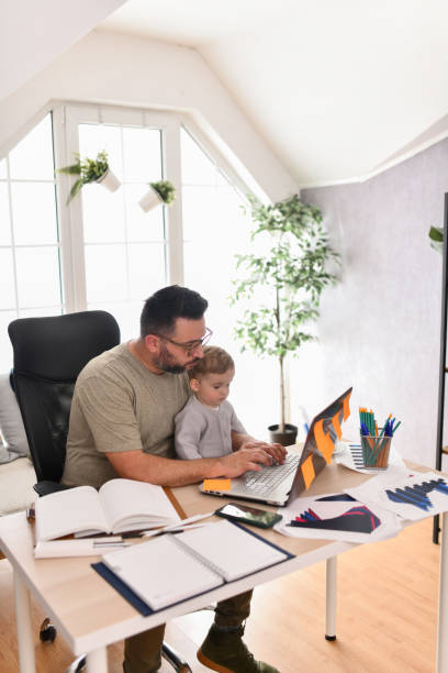 istock Father Teaching Baby Son The Basics Of Laptop Use 1497972427