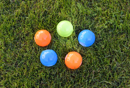 Closeup of mass produced, generic plastic water bombs that you can re-use which is great for the environment.