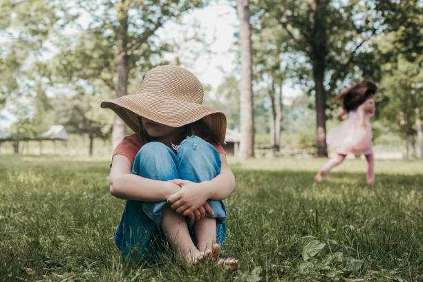 istock Cute kindergarten age girl wears sunhat and relaxes while playing outdoors at summer camp 1497975610