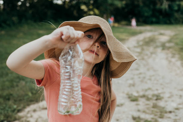 Young girl with balloon at riverside, sunny day activity capturing childhood joy which she spend in south Bavaria.
