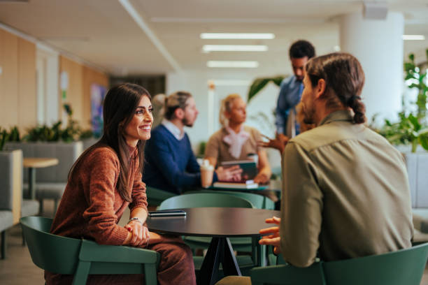 istock Coworkers enjoy break in office. 1497975730