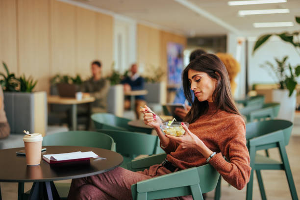 istock Caucasian businesswoman eat breakfast at work. 1497975731