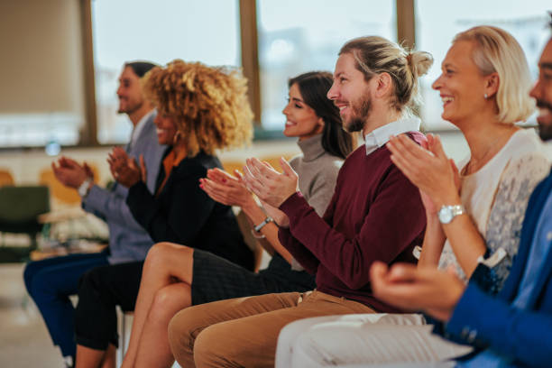 istock Excited audience clapping in meeting. 1497975759