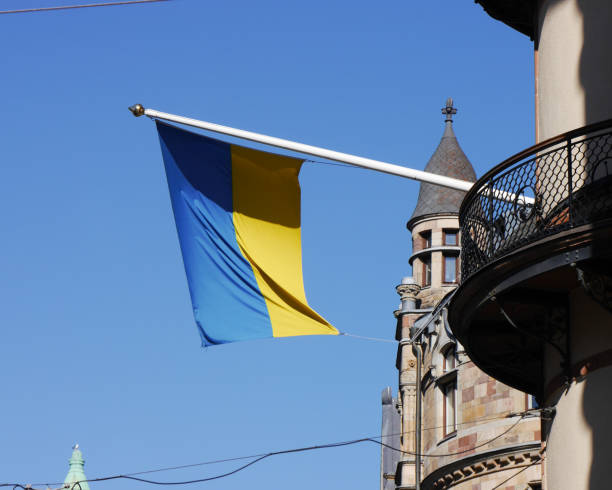 istock Low angle view of flag on building against clear blue sky 1497978006