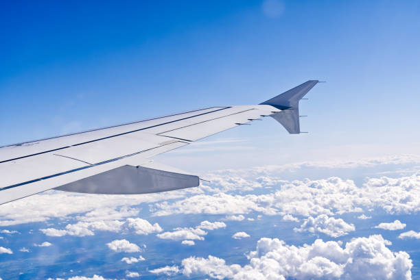 istock Wing aircraft in altitude during flight. clear sky in sunny day. 1497979119