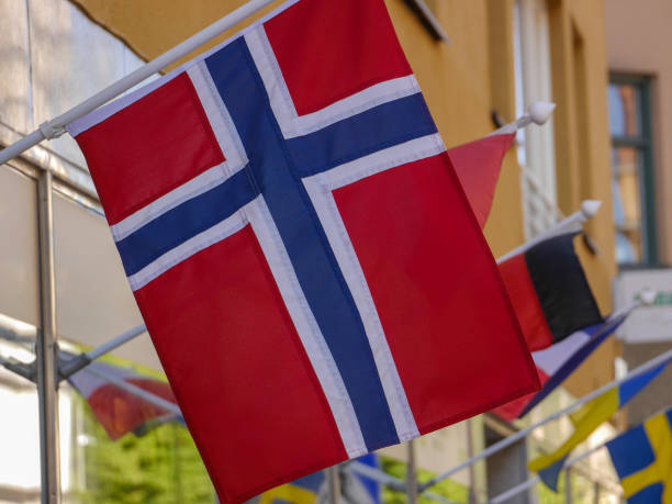 istock Low angle view of flag waving against building 1497981083