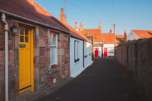 Colourful residential homes along a quiet lane in the quaint and charming old town of the seaside coastal fishing village of Crail, East Neuk, Fife, Scotland, UK.