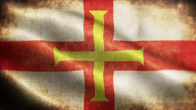 Closeup of grunge Guernsey waving flag loopable stock video