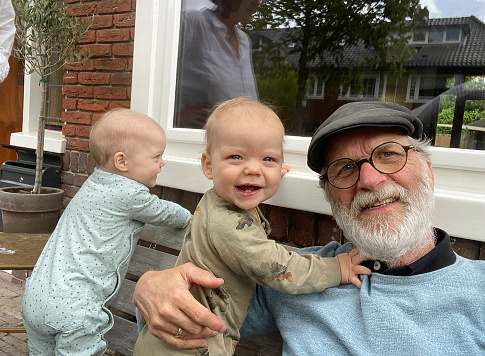 Happy Gandfather together with the baby twin