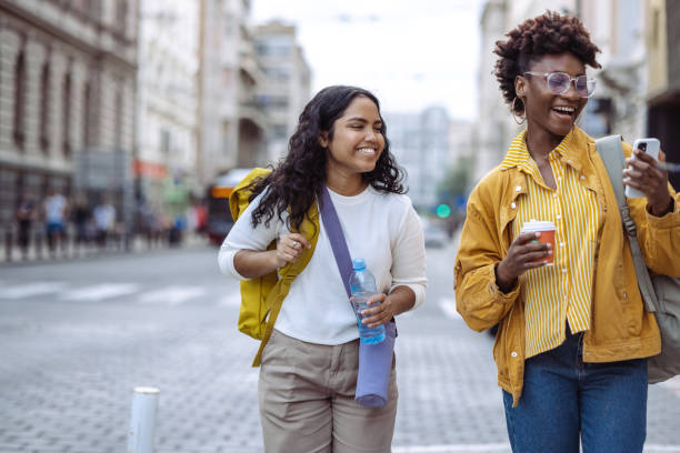 istock Female tourists using smart phone in the city 1497995982