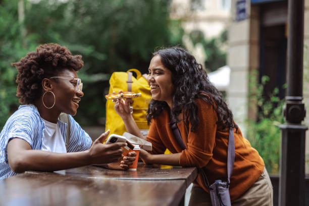 istock Friends having fun and eating fast food 1497996415