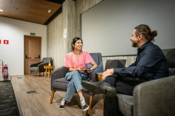 Young woman interviewing a man at studio