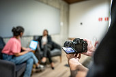 Cameraman recording video on camera in a seminar