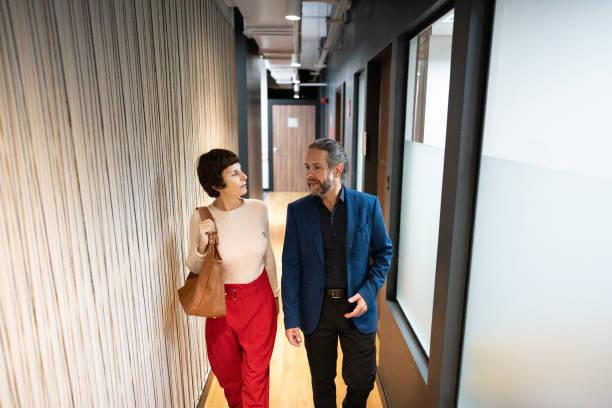 istock Business person/coworkers talking while walk at office 1498000487