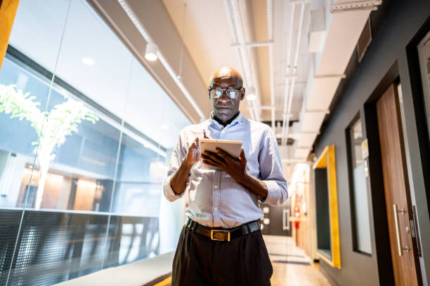 istock Mature businessman working using a digital tablet at office 1498001811