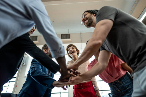 istock Coworkers with stacked hands at the office 1498003786