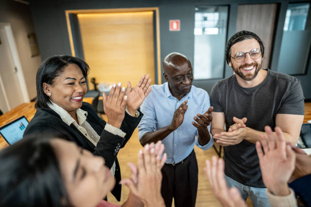 istock Coworkers celebrating and clapping at office 1498003837