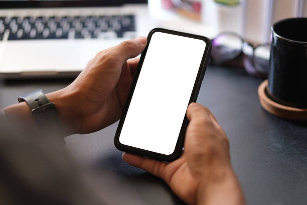 istock Close up view man holding smart phone with empty display. 1498004644