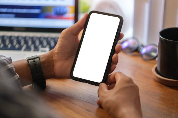 istock Close up view of man holding mock up smart phone with blank screen. 1498005233