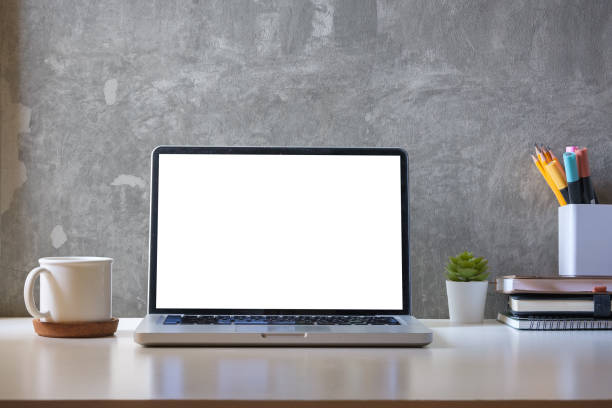 istock Laptop computer, coffee cup, potted plant and picture frame on creative workplace. Blank screen for your advertise text. 1498005809