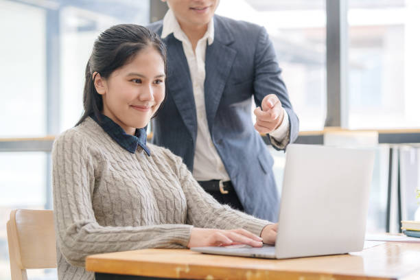 istock Two smiling business colleagues working on new project together. 1498006454
