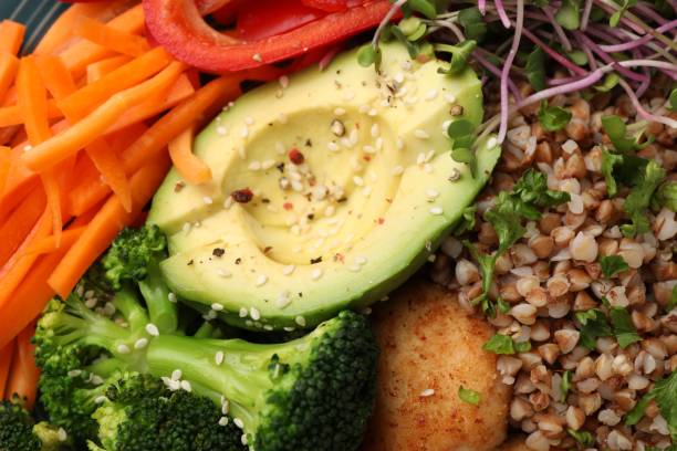 istock Delicious vegan bowl with avocado, broccoli and buckwheat as background 1498009603