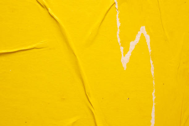 istock Old grunge ripped torn yellow paper poster surface texture background 1498011703