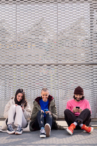 istock friends scrolling through social media with phone 1498011764