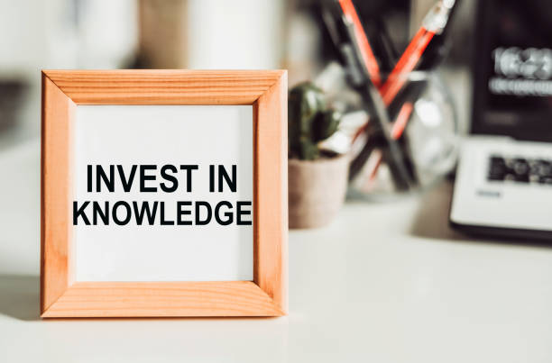 istock Wooden frame with office background with text INVEST IN KNOWLEDGE 1498012374